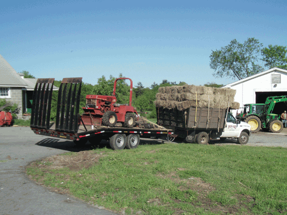 Pickard Farm ready to install another silt fence with hay bales loaded and ditch witch in tow.